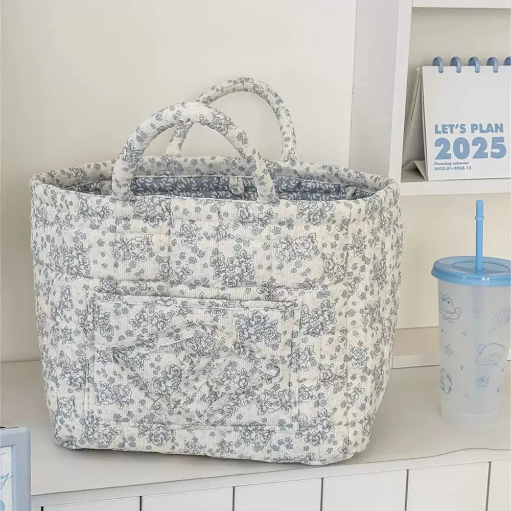 Charcoal floral quilted storage basket with handles and front pocket